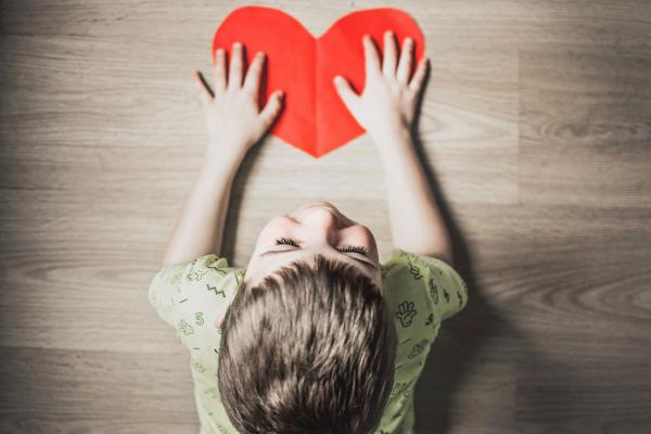 boy with red paper heart